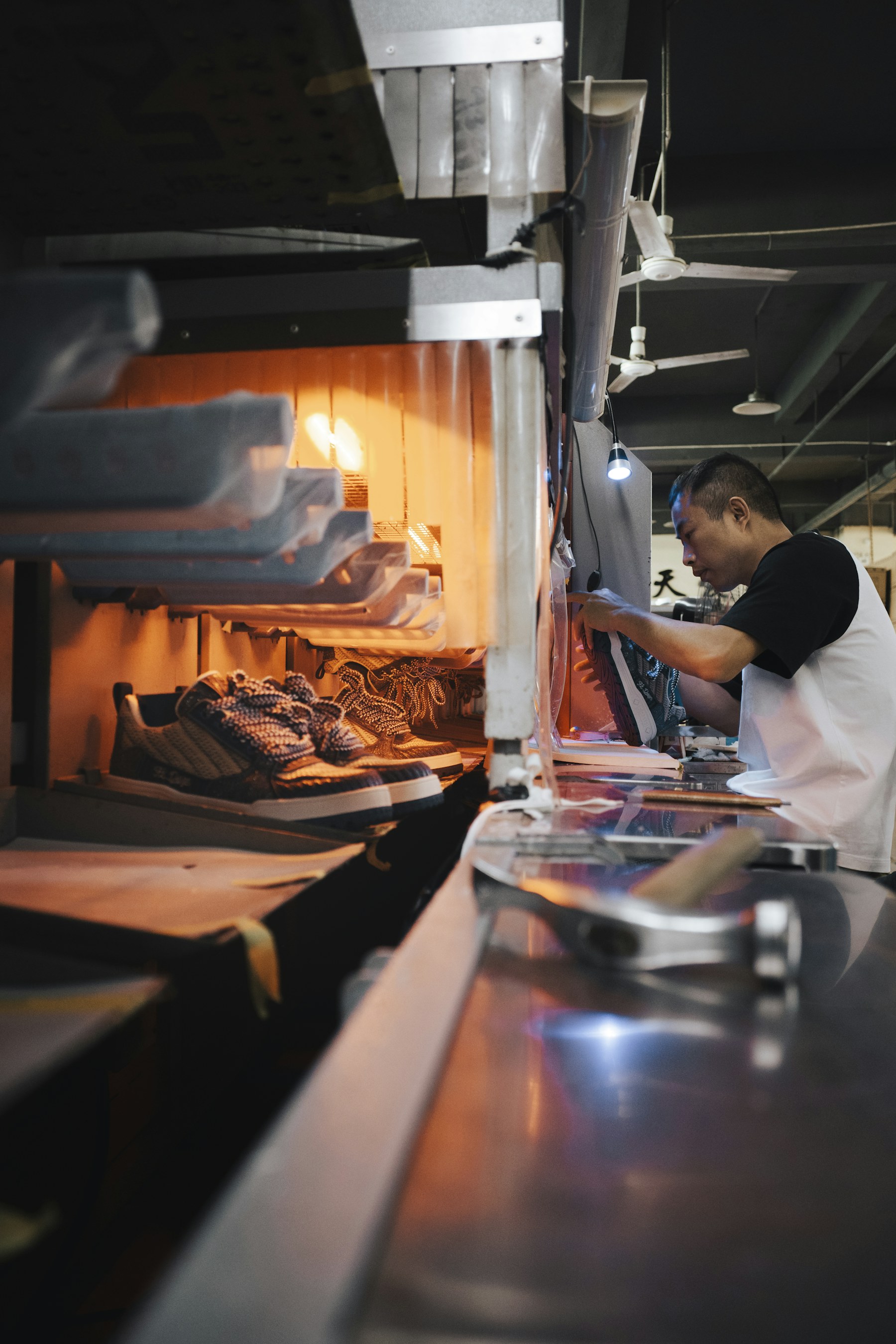 China footwear sourcing specialist working beside a shoe production line